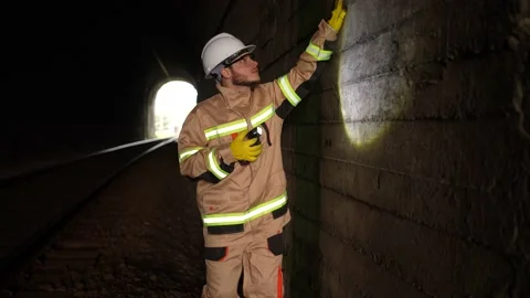 A railway engineer worker with a lantern in his hands checks the condition of Video stock 235217068