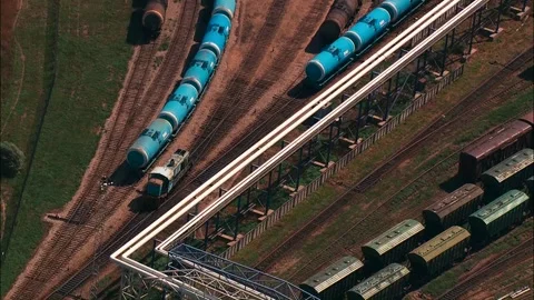 Railway junction viewed from above with goods wagons and lone moving locomotive Stock Footage 245959612