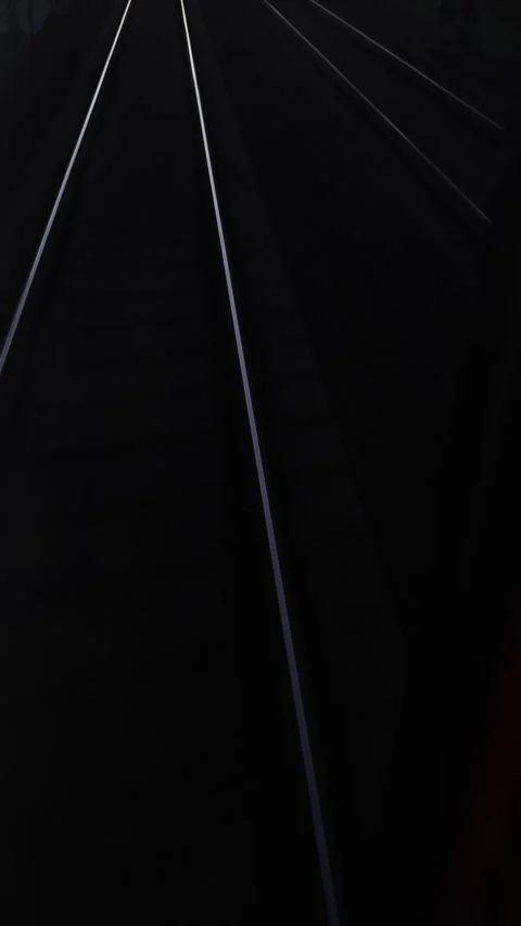 Railway lines in darkness create solitude and motion Stock Footage 332620236