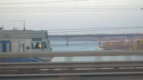 Railway lines shines by sun rays, over Dnipro river. Kyiv Stock Footage 107873818