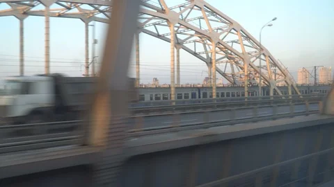 Railway lines shines by sun rays, over Dnipro river. Kyiv Stock Footage 107874059