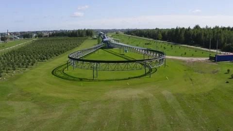 Railway loop with unicar between garden and meadow aerial Stock Footage 119909631