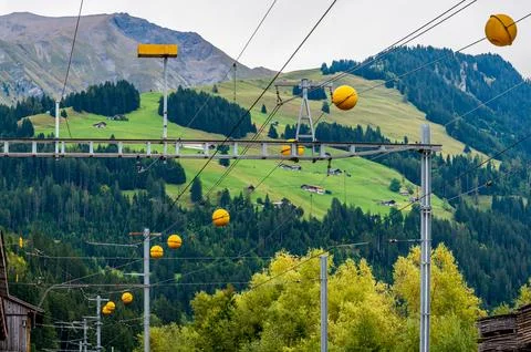 Railway Overhead Power Lines with Yellow Warning Markers in Switzerland Stock Photos