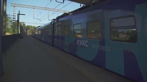Railway platform and a passing blue train 4K Stock Footage 156846641