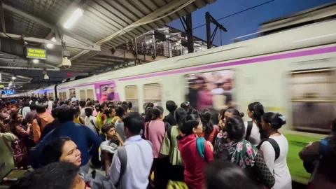Railway platform packed with people train arrives. 4K Stock Footage 247891864