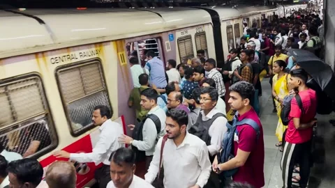Railway platform packed with people train arrives, Crowds move to board train. Stock Footage 248056784