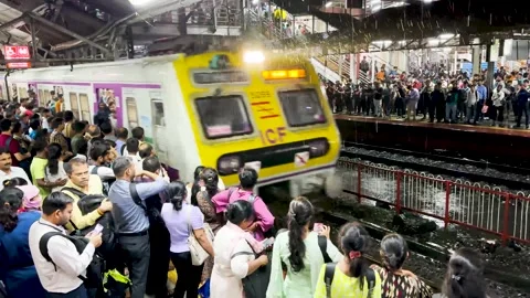 Railway platform packed with people train arrives. 4K Stock Footage 248408557