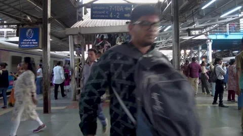 Railway station platform with a crowd of people walking and commuting Видео 341324669