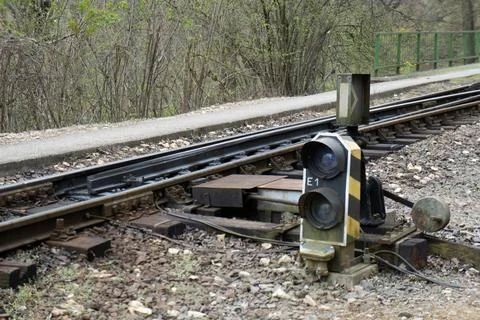 Railway switch with pebbles on a cloudy day Stock Photos