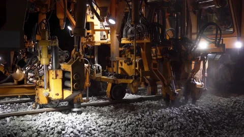 Railway tamping machine operating on a section of track Stock Footage 328989930