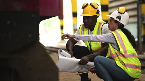 Railway technicians and engineers, Inspect the trains in train repair station Stock Footage 274878167