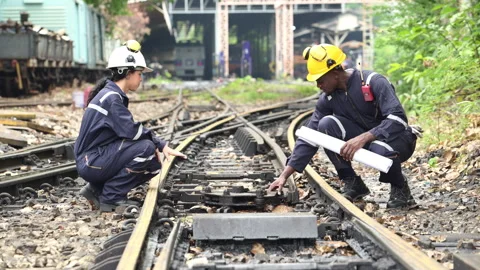 Railway technicians and engineers, Working on the train tracks at train station Stock Footage 274873220