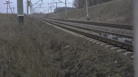Railway track, isolators, grey grass in the Ukrainian fields. 4K Video stock 60428789