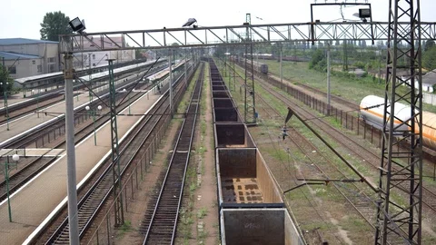 Railway tracks, freight train with empty cars, the camera is lowered, in the Stock Footage 91695431