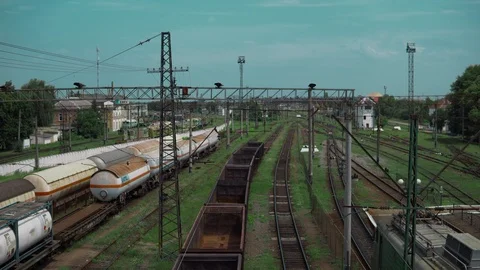 Railway tracks, freight train with empty cars, the camera turns, in the Stock Footage 91695492