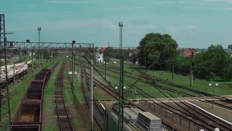 Railway tracks, freight train with empty cars, the camera turns, in the Video stock 91695564
