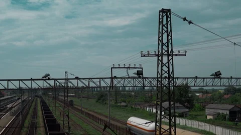 Railway tracks, freight train with empty cars, the camera turns, in the Stock Footage 91698102