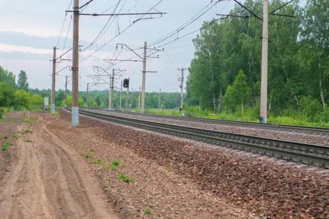 Railway tracks in the middle of the spring forest Stock Photos
