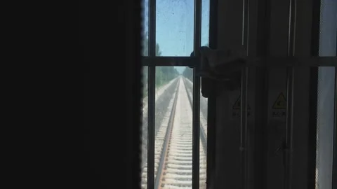 Railway Tracks Receding Behind a Moving Green Train in Xinjiang Stock Footage 343706849