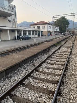 Railway tracks run past the platform and station building at Bar railway station Stock Photos