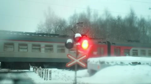 Railway traffic light and a passing train in winter through the window Stock-Footage 296125137