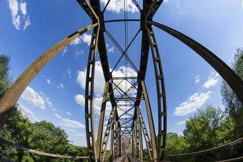 Railway viaduct in the UWA wide-angle lens on a sunny day. Summer. Stock Photos