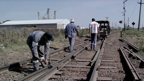 Railway Worker Adjusting Train Track, Manual Rail Maintenance in Argentina - 4K Stock Footage 329326175