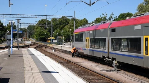 Railway worker checking hatches on train Stock Footage 91967670