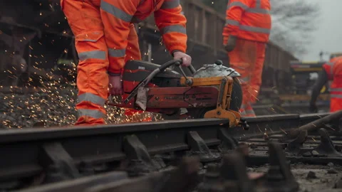 Railway Worker Cuts Track With Rail Cutter And Sparks Fly - In Slow Motion Stock Footage 239428664