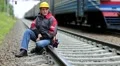 Railway worker sits on railway line HD Footage