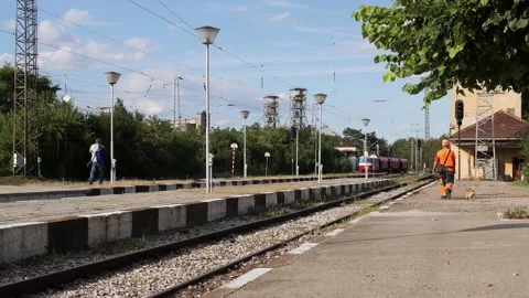 Railway worker walking along the platform at a train station Stock Footage 345638167