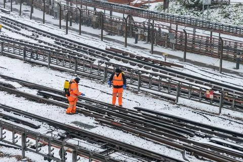 Railway Workers De-Icing Snow-Covered Tracks in London Stock Photos