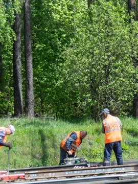 Railway workers work on the tracks. Stock Photos