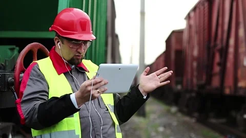 Railwayman speaks via tablet computer Stock Footage 86490840