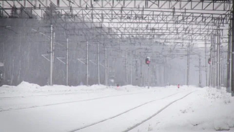 Railways in the snow. Perspective view of railways traffic lights in winter. Stock Footage 117843555