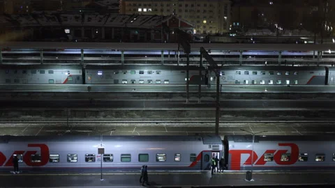 Railways view from window. Night winter time lapse. Passengers board train Stock-Footage 295378889