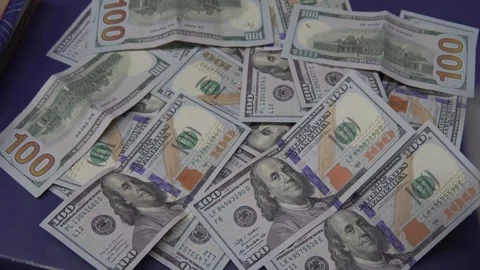 Rain of 100 dollar bills on a table Stock Footage 272500533