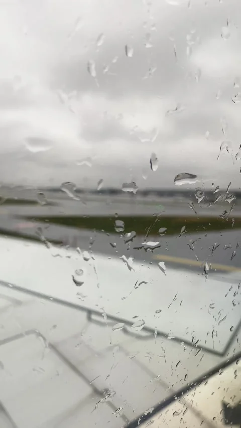 Rain on Airplane Window with Runway View Stock Footage 299938158