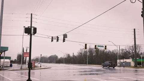 Rain and 4 way intersection traffic in small town USA Georgia Stock Footage 235898772