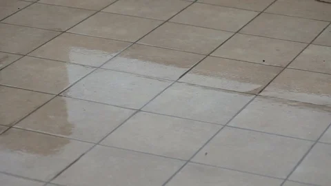 Rain and drops of water falling on the stone slabs in the yard.. Mallorca, Cala Stock Footage 76032079