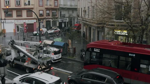 Rain and hailstorm are going down. Valencia cityscape with traffic on wet roads Stock Footage 144889846
