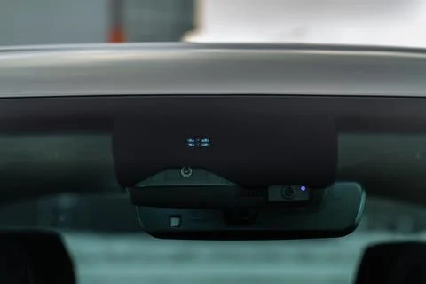 Rain and light sensor on the windshield of the car. Modern car safety feature Stock Photos