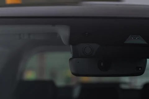 Rain and light sensor on the windshield of the modern car. Stock Photos