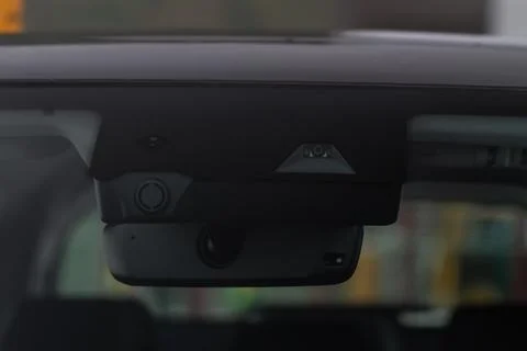 Rain and light sensor on the windshield of the car. Modern car safety feature Stock Photos