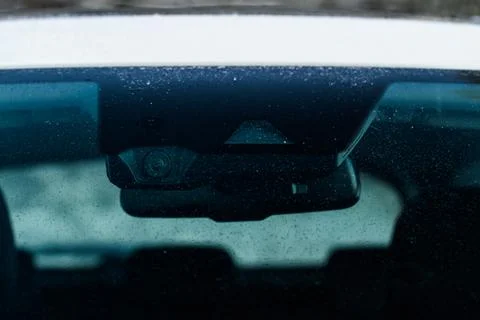 Rain and light sensor on the windshield of the car. Modern car safety feature Stock Photos