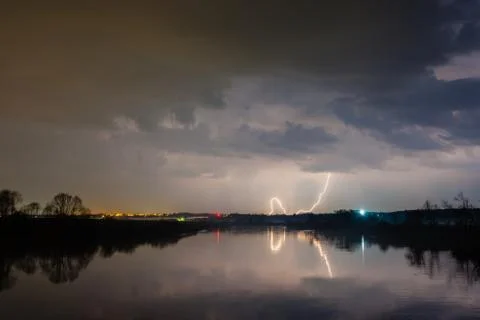 Rain and lightning above the river Stock Photos