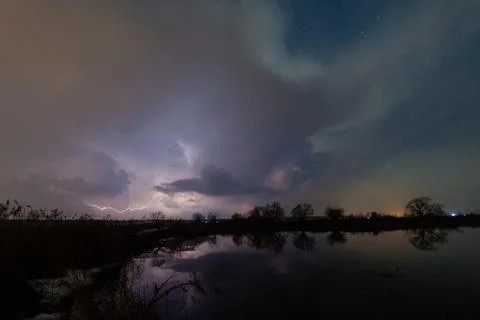 Rain and lightning above the river Foto stock