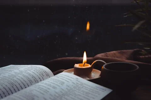 Rain and raindrops falling on the window, candles, crosses and bibles Stockfoto's