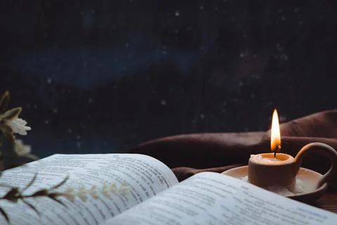 Rain and raindrops falling on the window, candles, crosses and bibles Stockfoto's