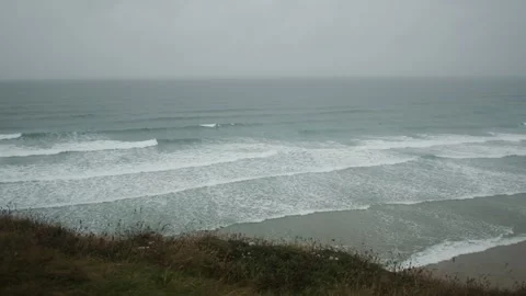 Rain and Sea and Surf - Waves rolling in on the beach Stock Footage 282901175